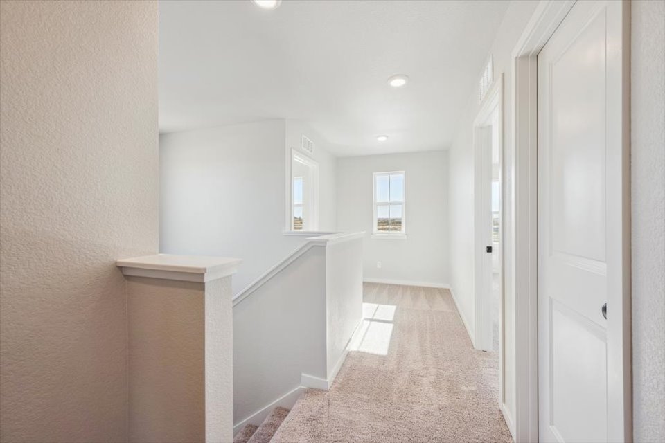 A hallway with white doors.