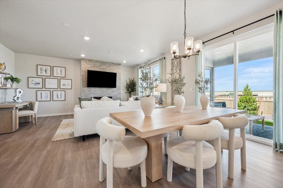 A large living room with a large table and chairs.