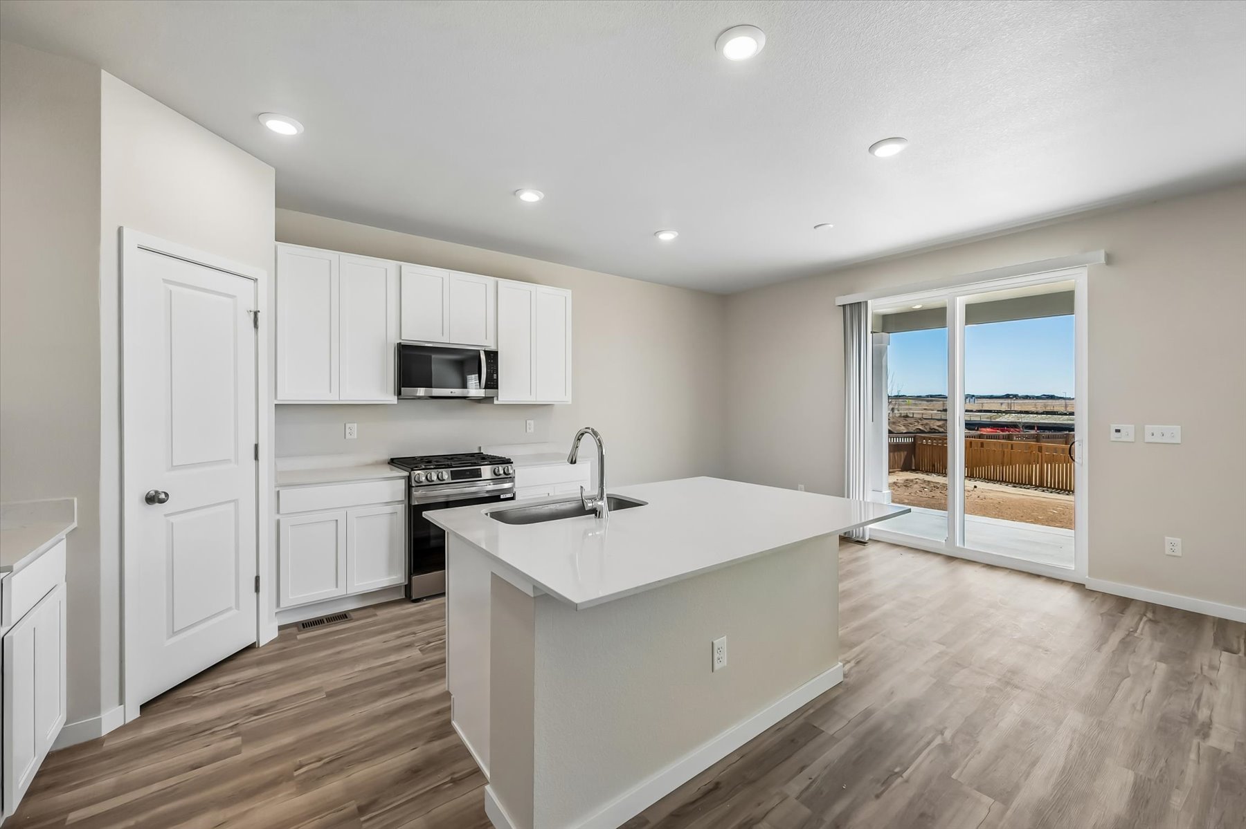 A kitchen with white cabinets.