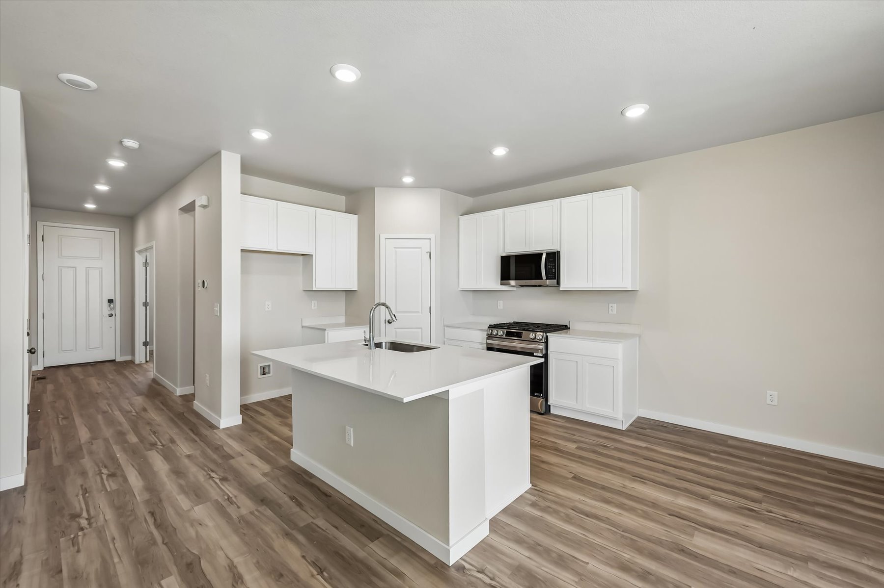 A kitchen with white cabinets.