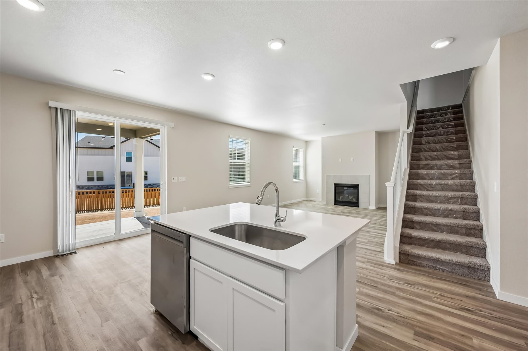 A kitchen with a large staircase.