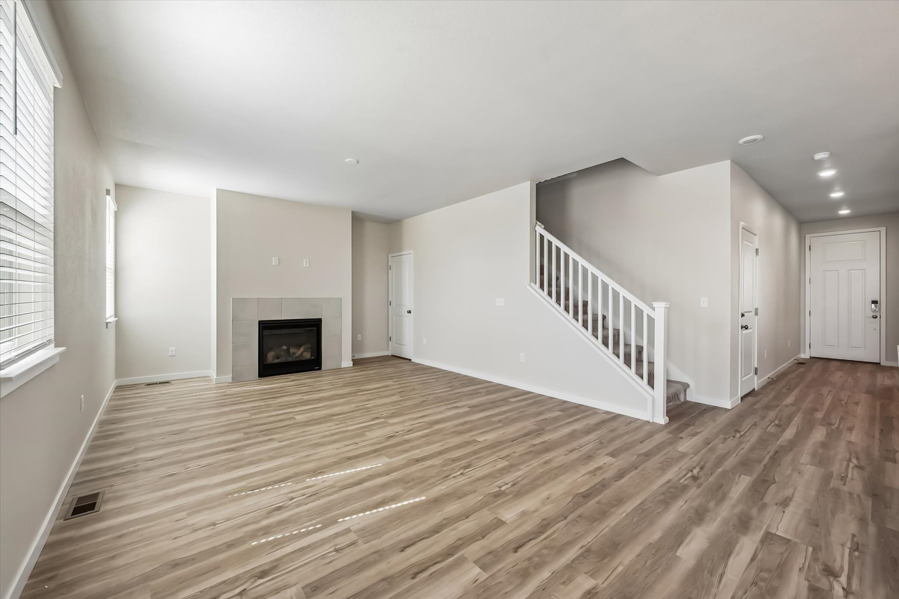 A large empty room with a fireplace.
