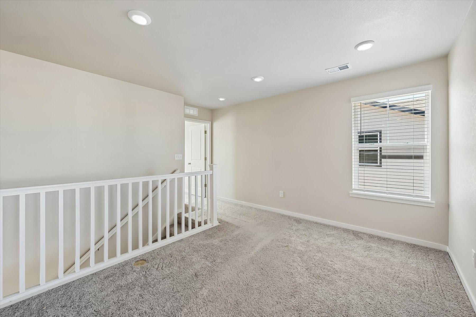 A room with a white railing and a white railing.