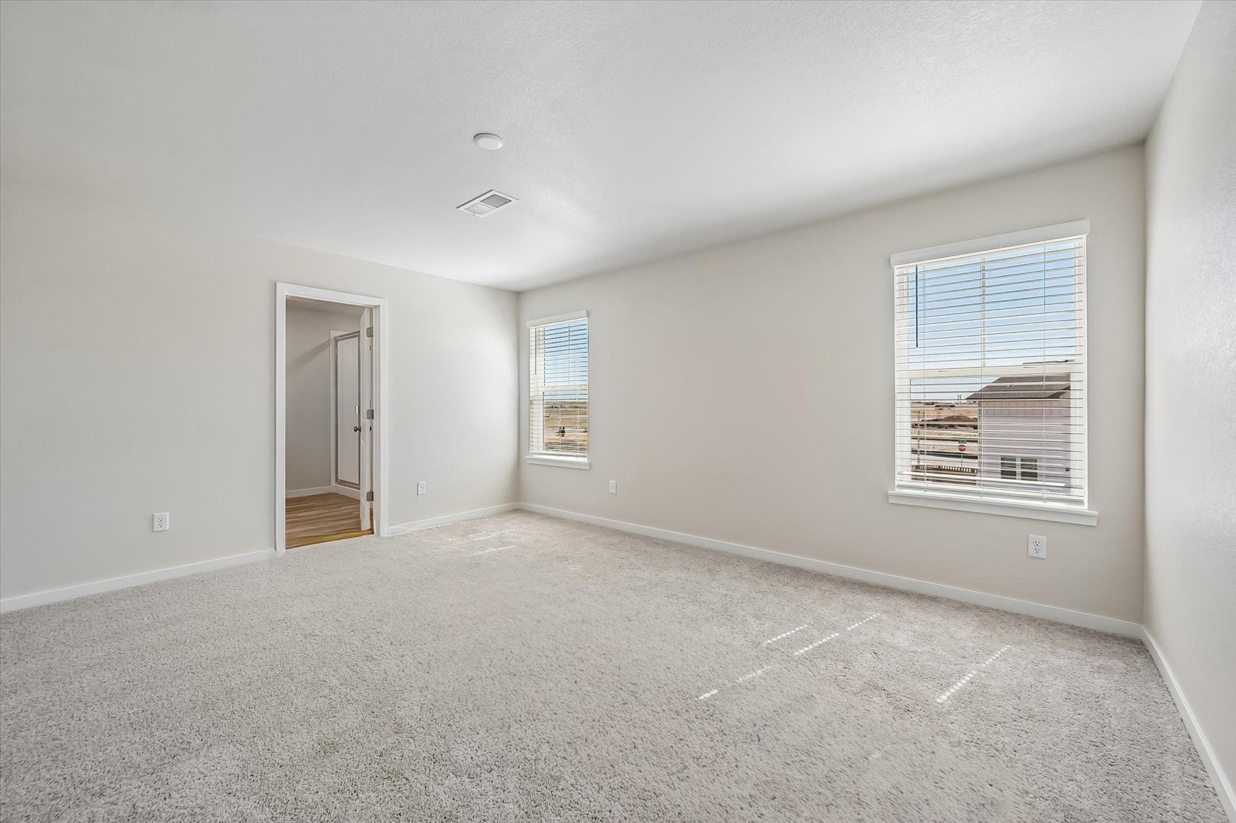 A room with a door and windows.