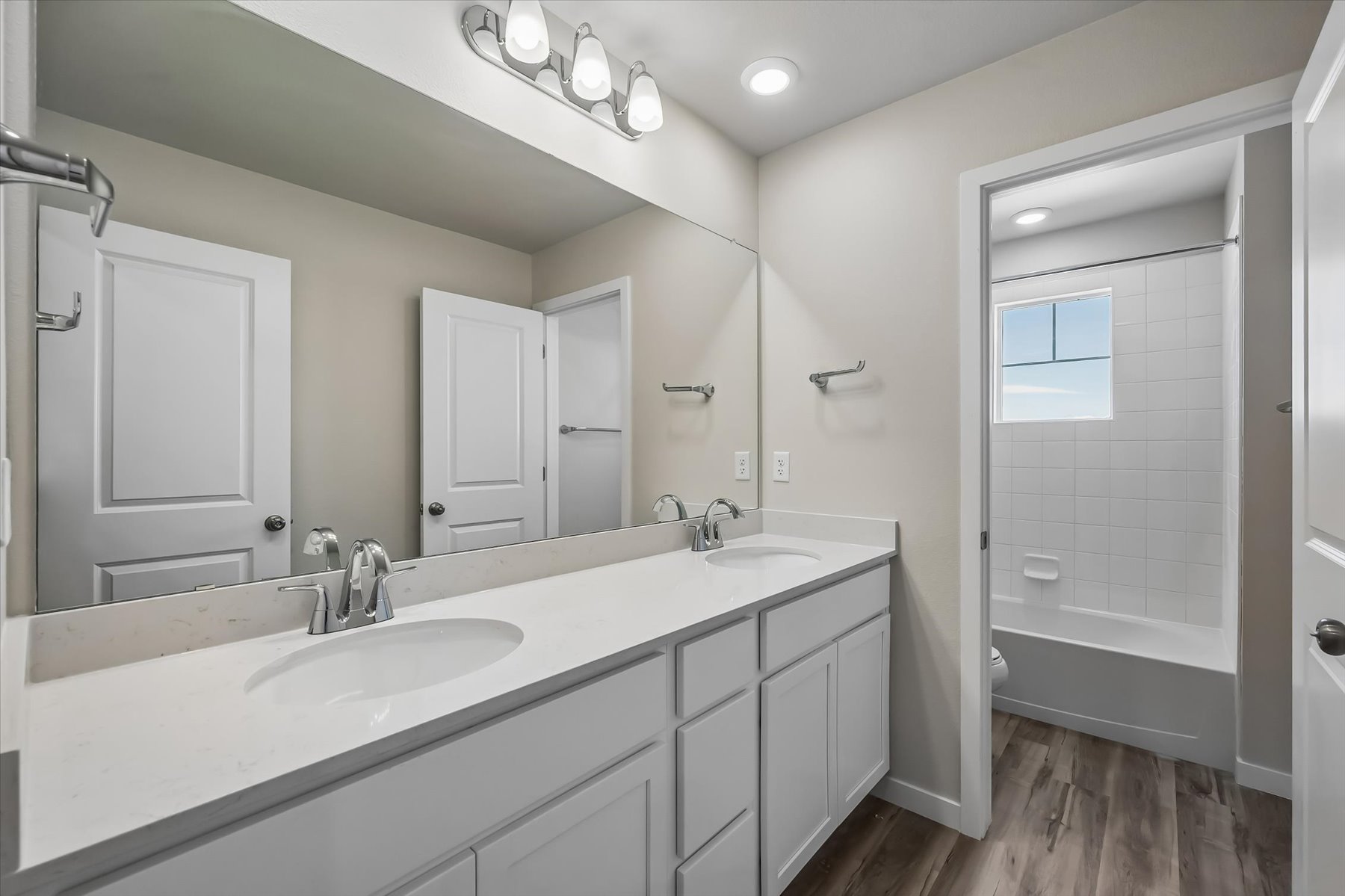 A bathroom with a sink and a shower unit.