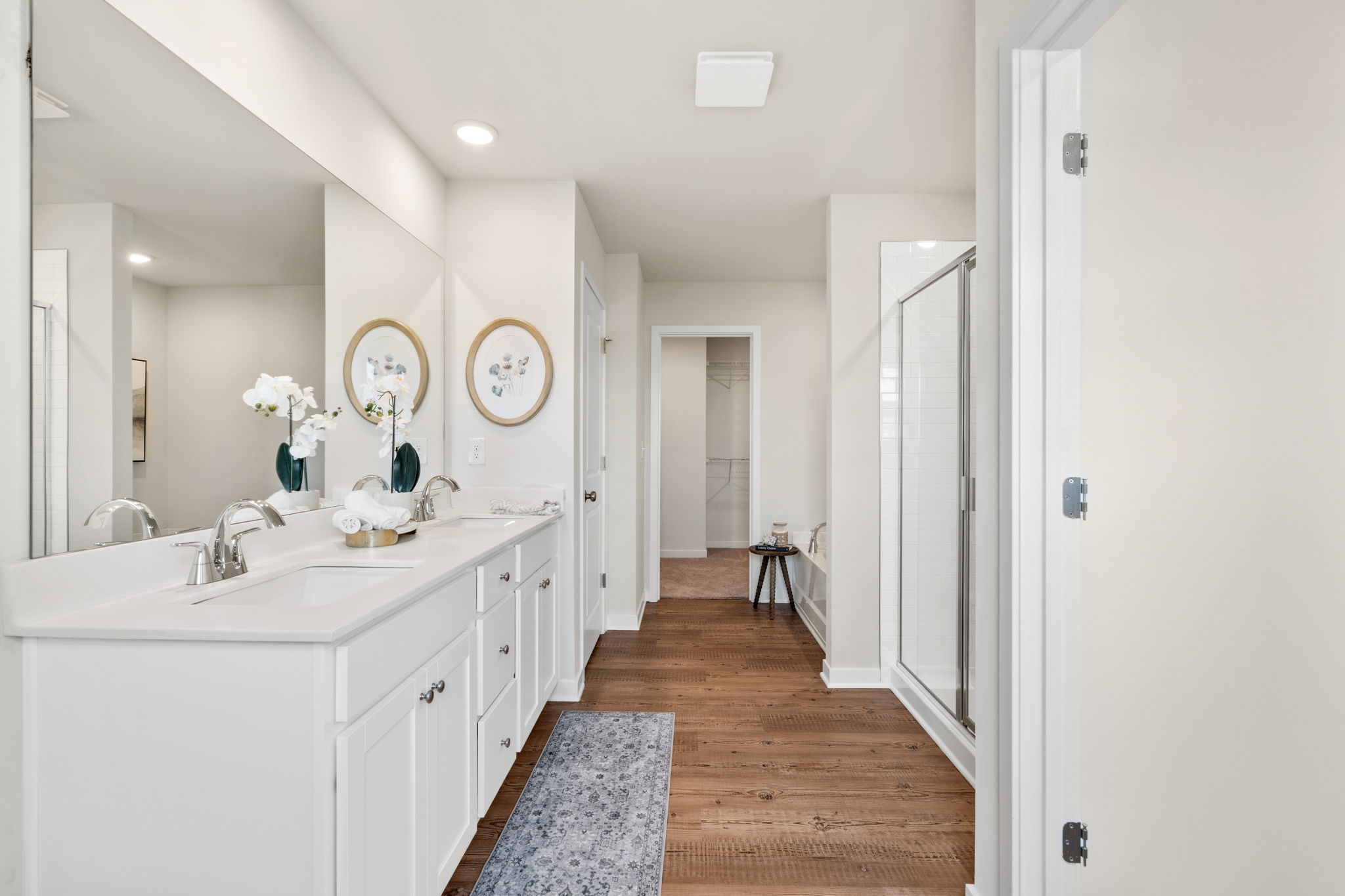 A bathroom with white cabinets.