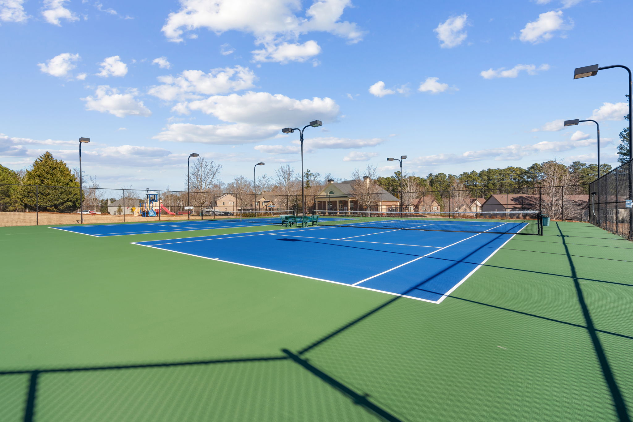 A tennis court with a blue court.