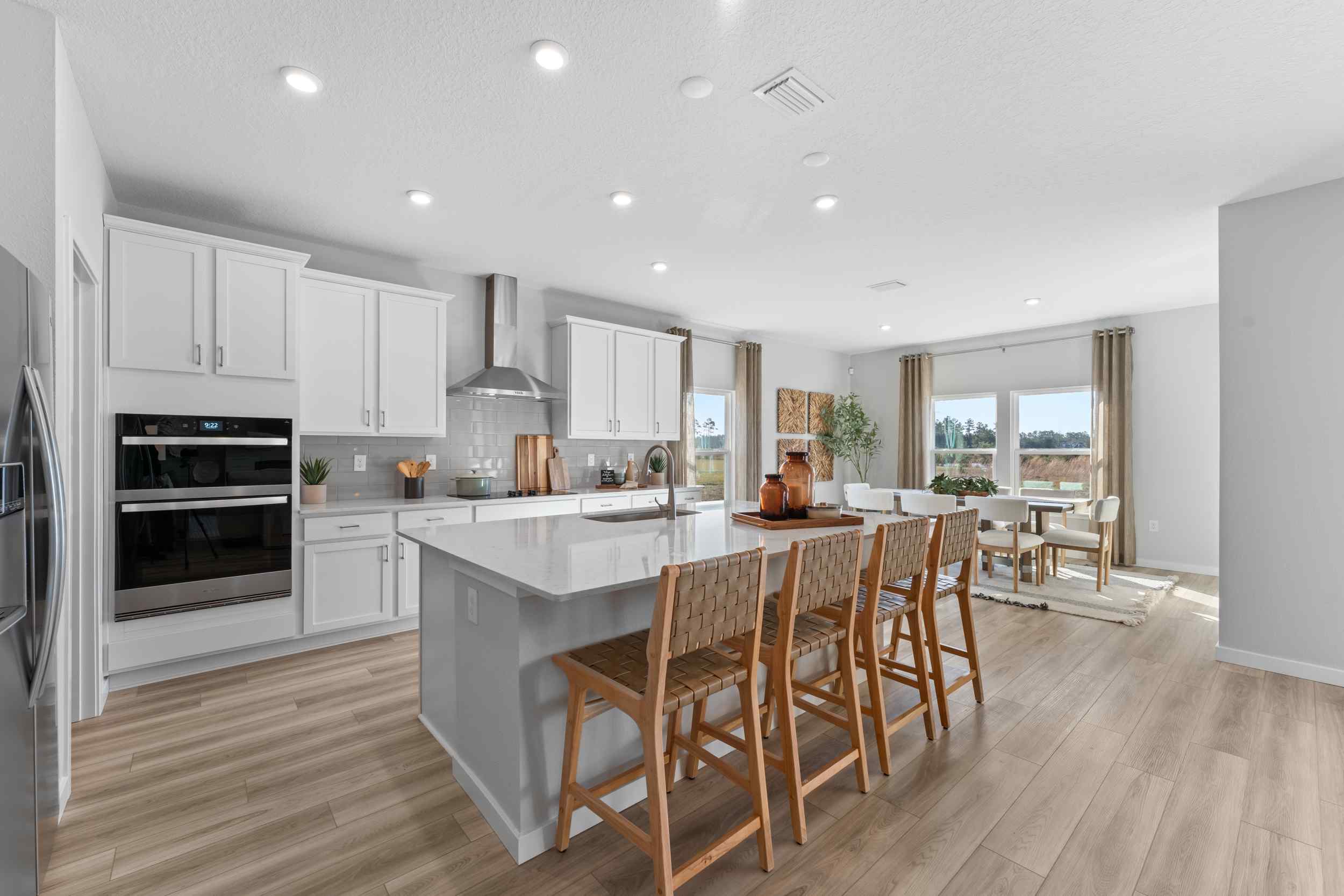 A kitchen with a dining table and chairs.