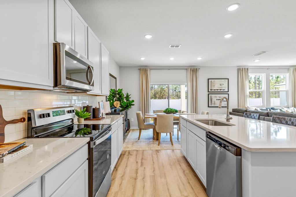 A kitchen with white cabinets.