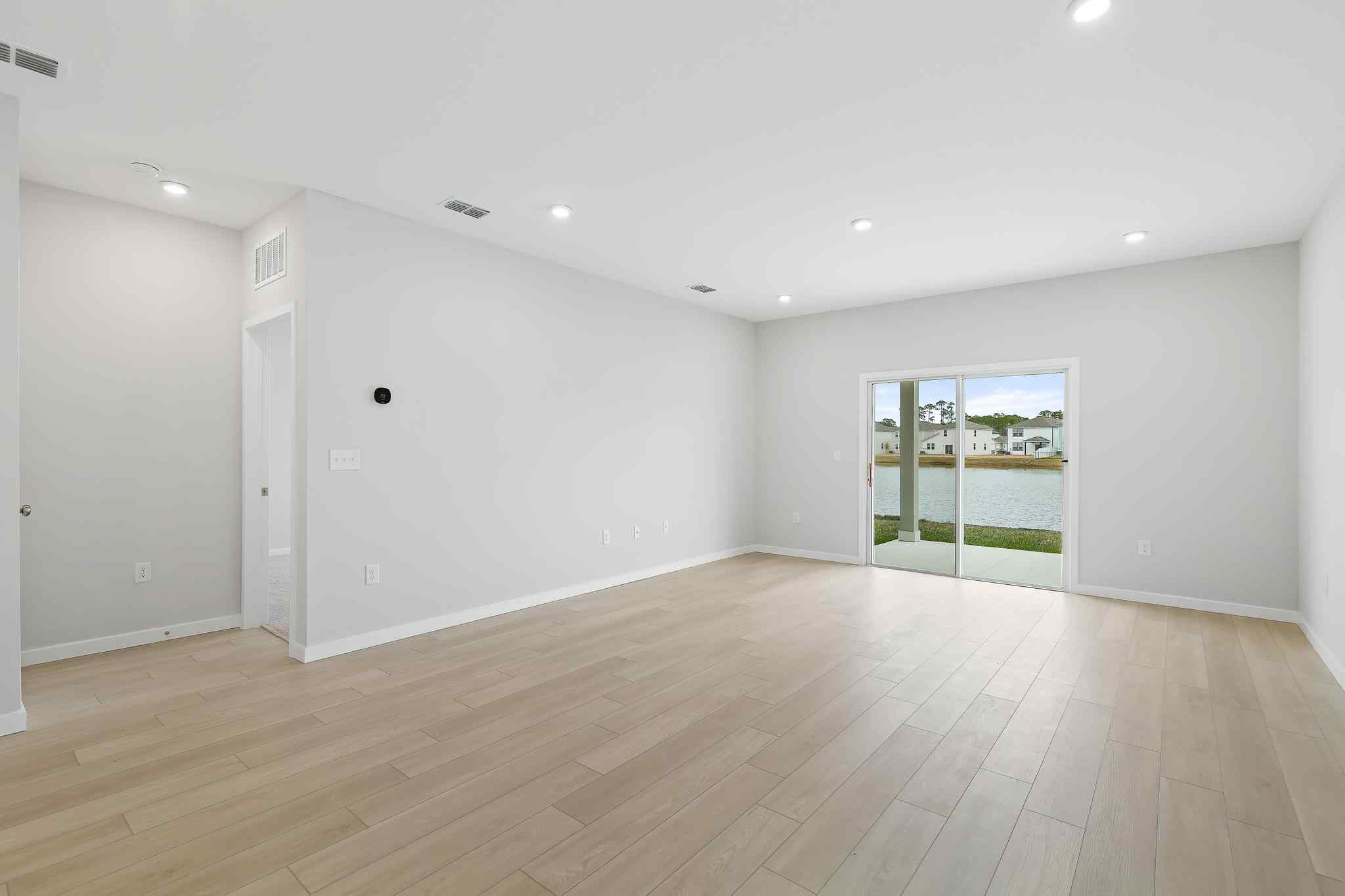 A room with white walls and a wood floor.