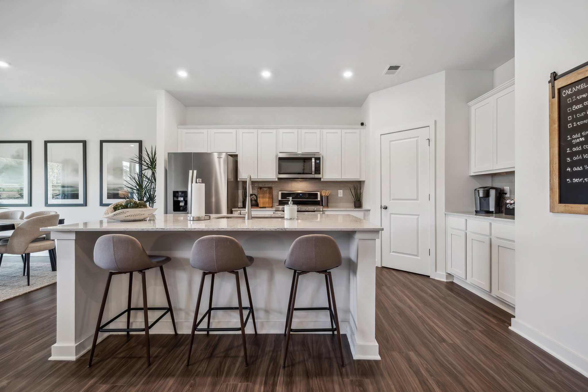 A kitchen with white cabinets.