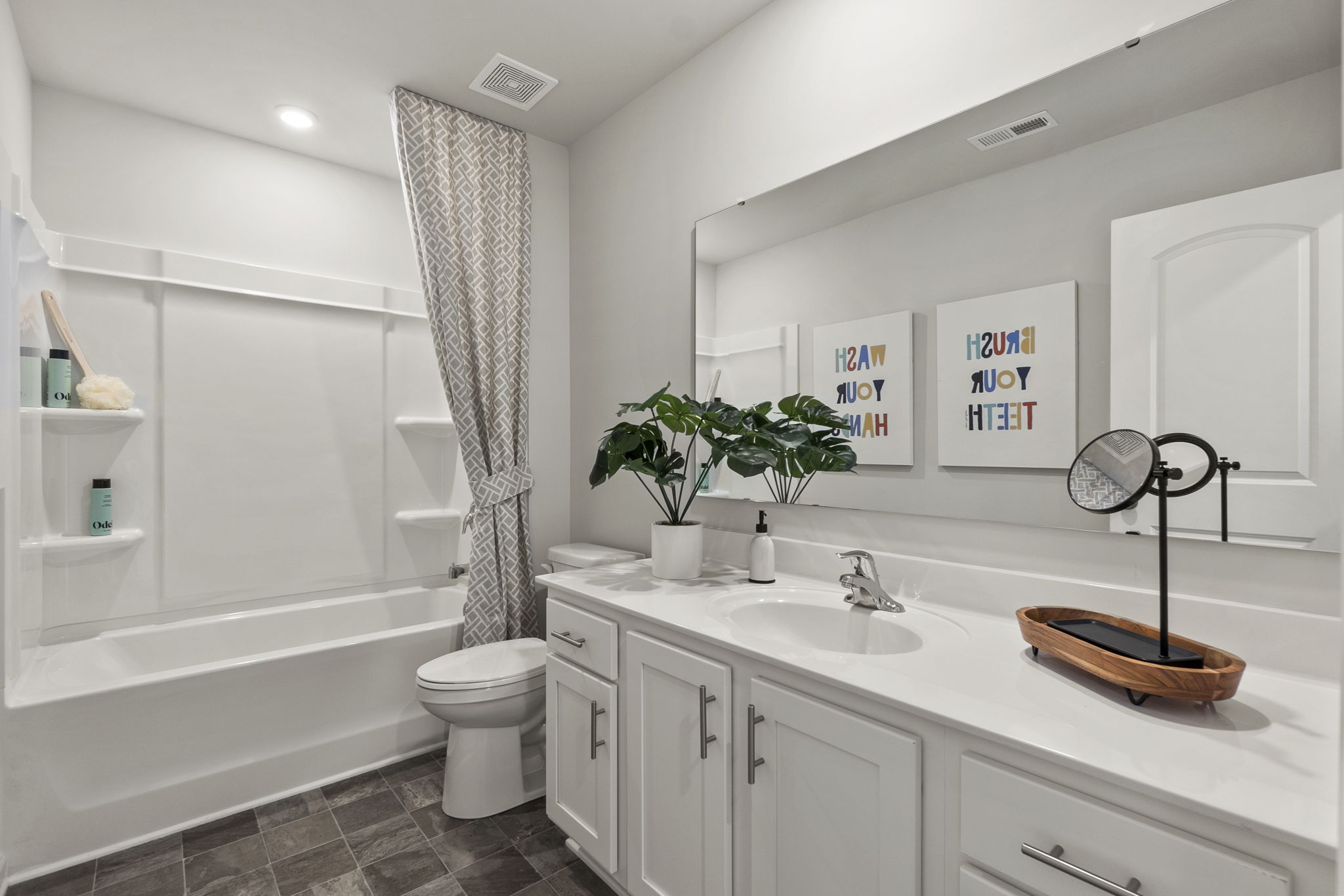 A bathroom with a tub sink and toilet.