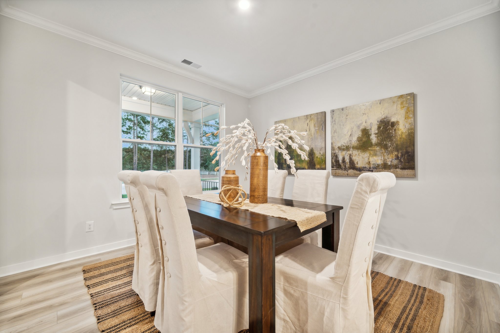 A dining room with a table and chairs.