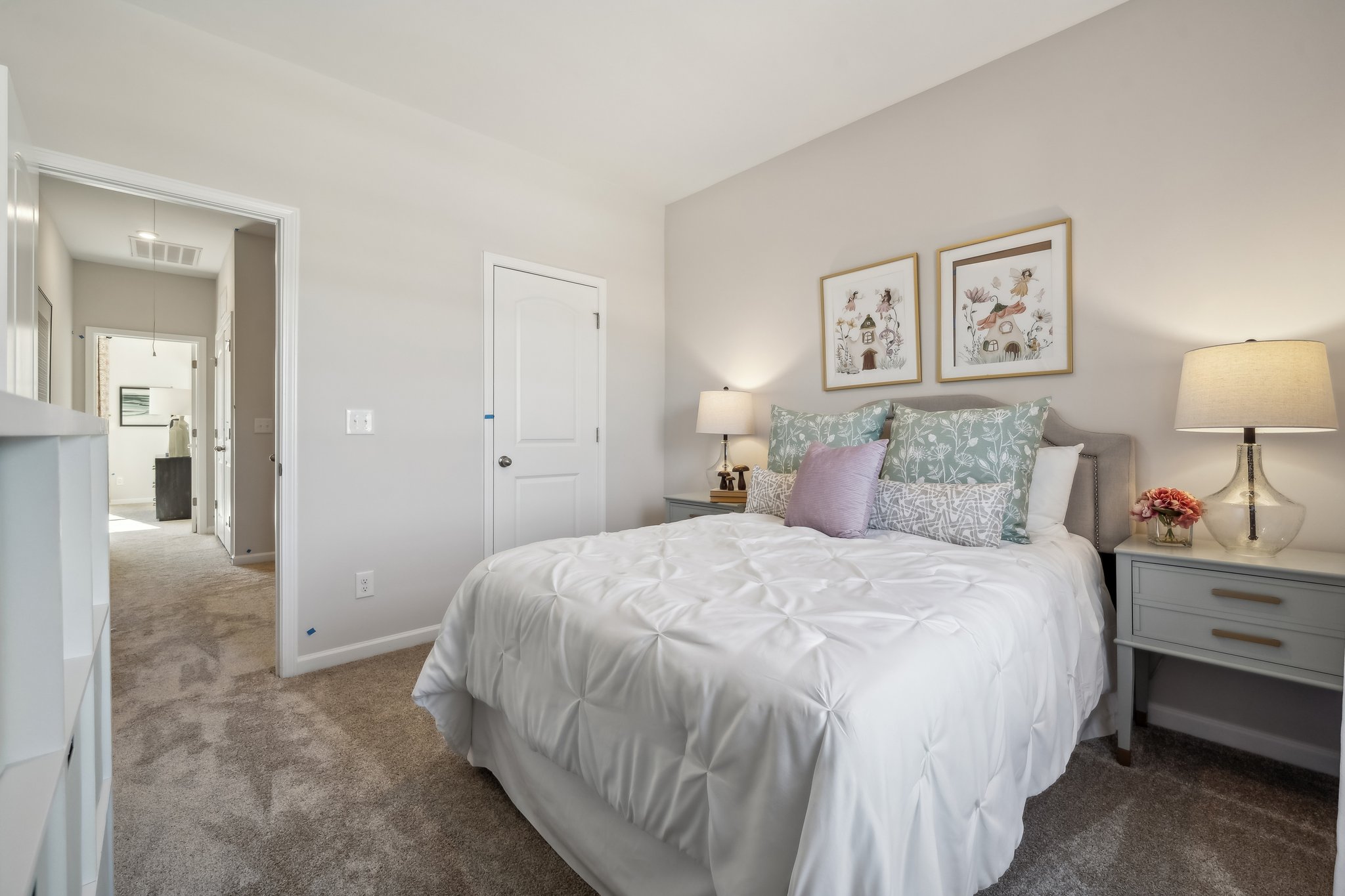 A bedroom with a bed and lamps.