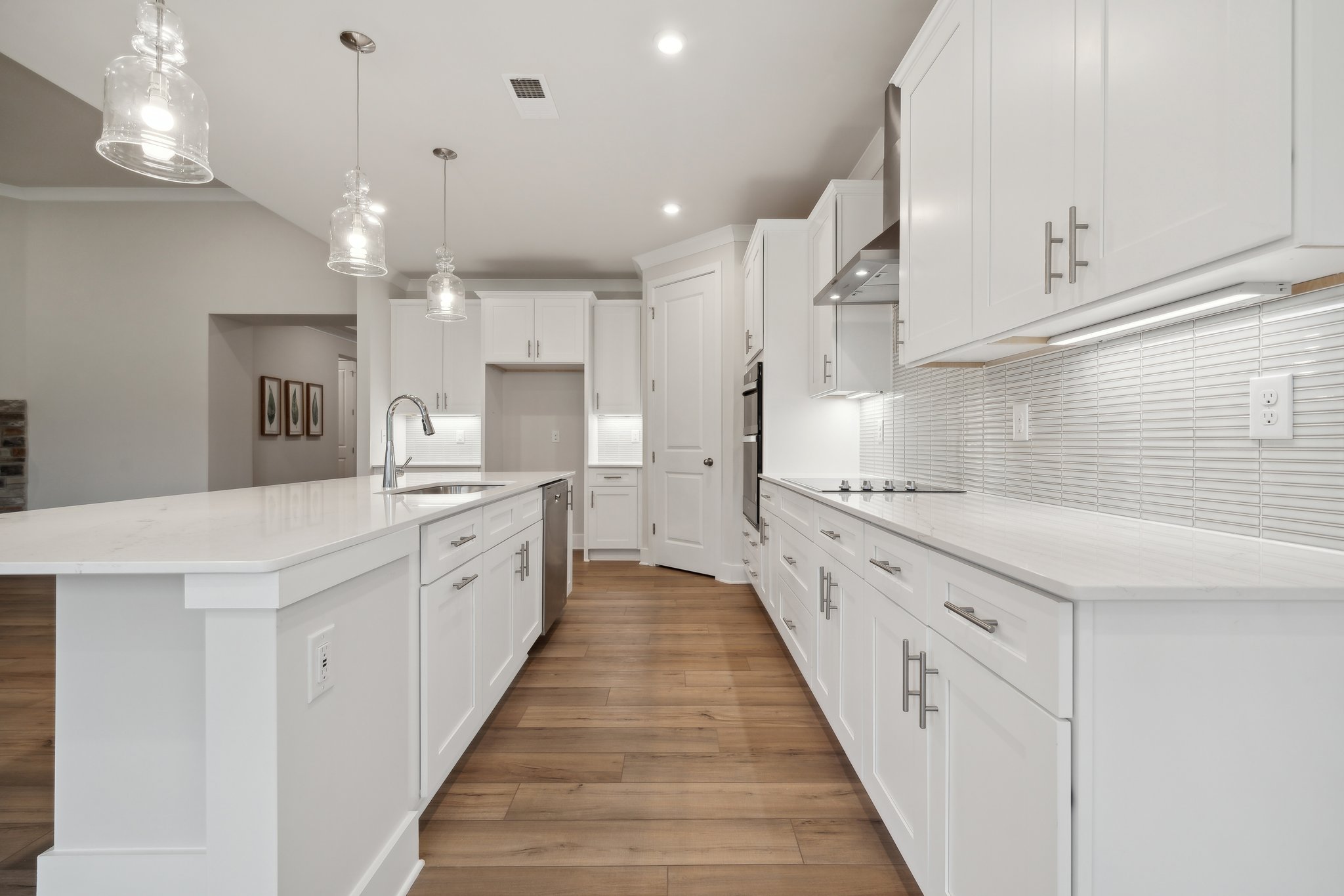 A kitchen with white cabinets.
