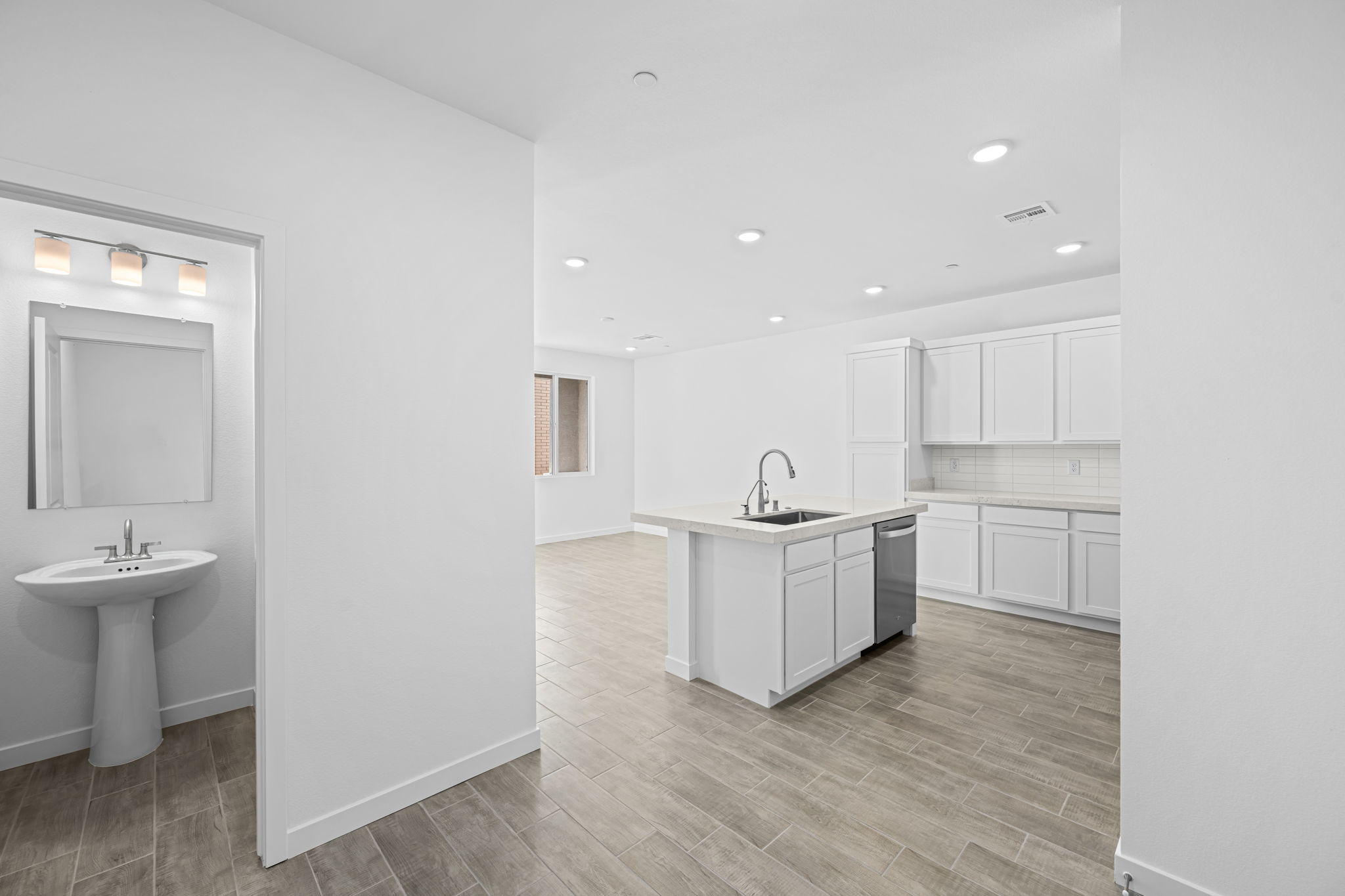 A bathroom with white cabinets.