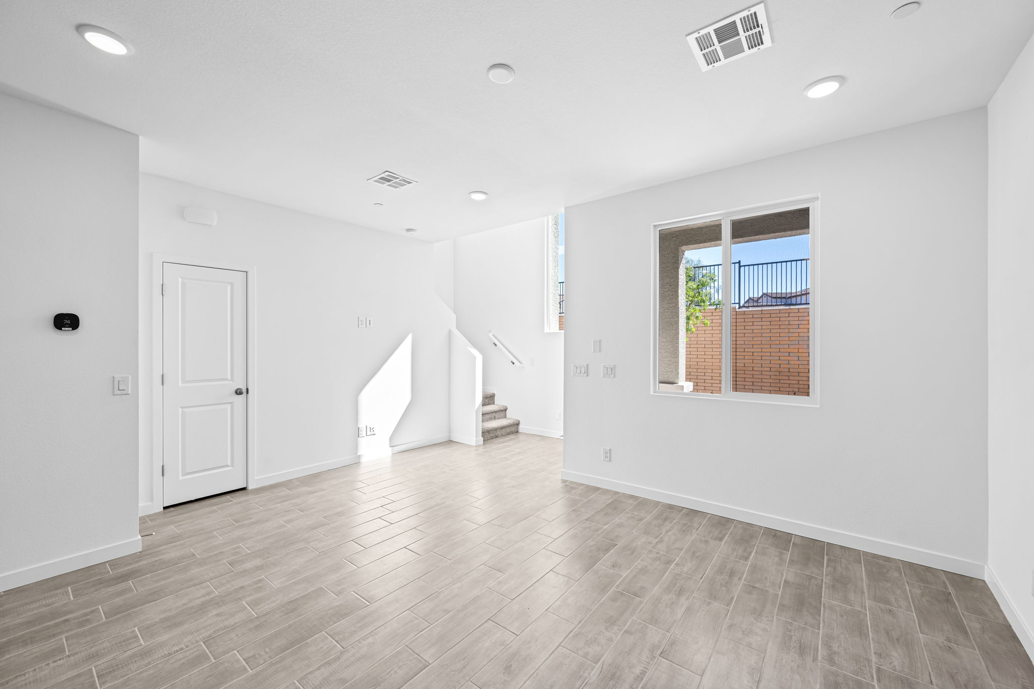 A room with white walls and a wood floor.