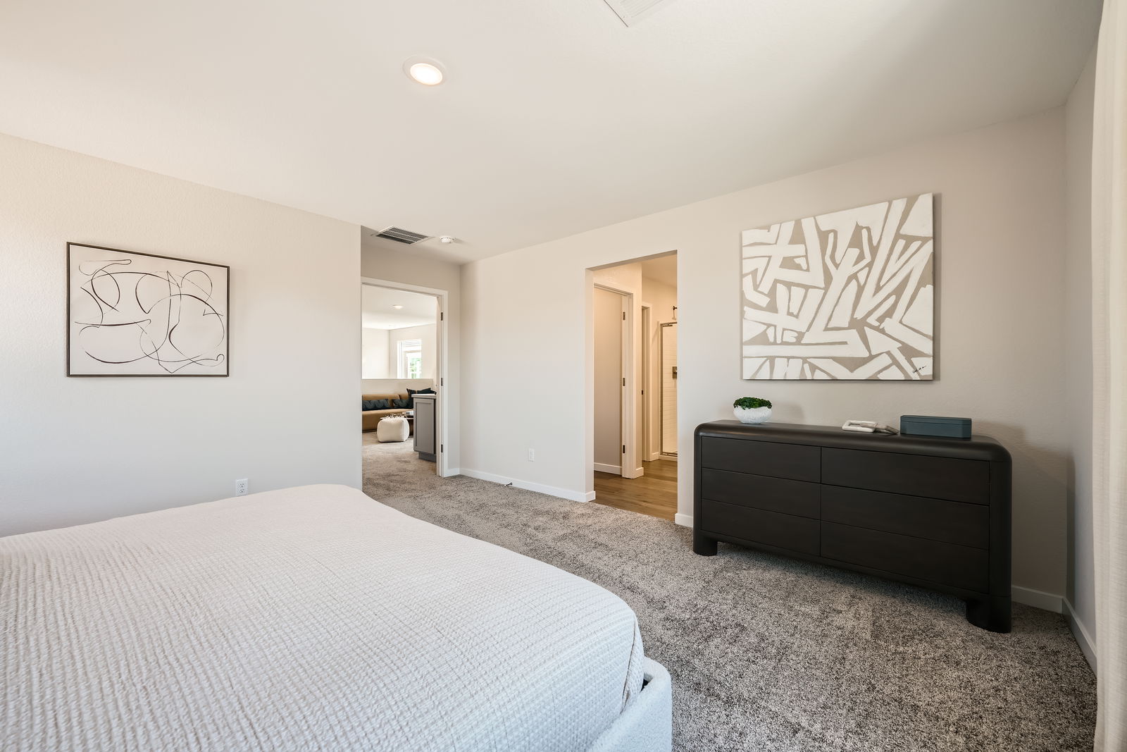 A bedroom with a bed and a desk.