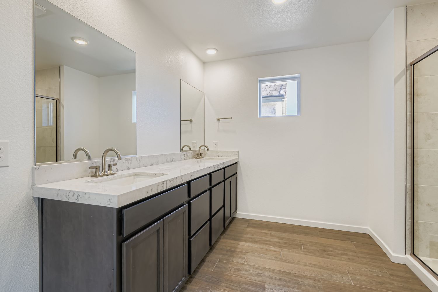 A bathroom with a large mirror.