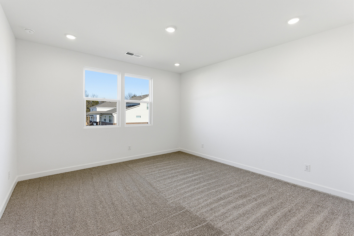 A room with a window and a carpet.