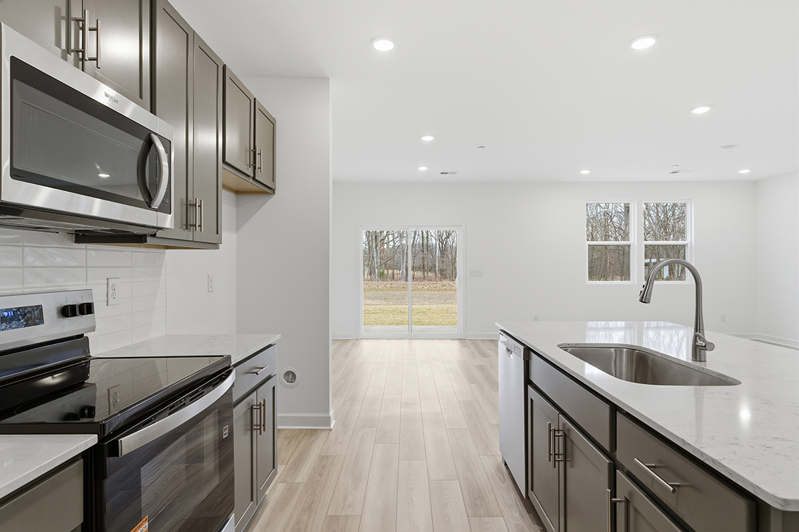 A kitchen with a wood floor.