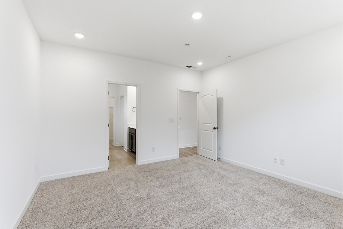 A hallway with white walls.