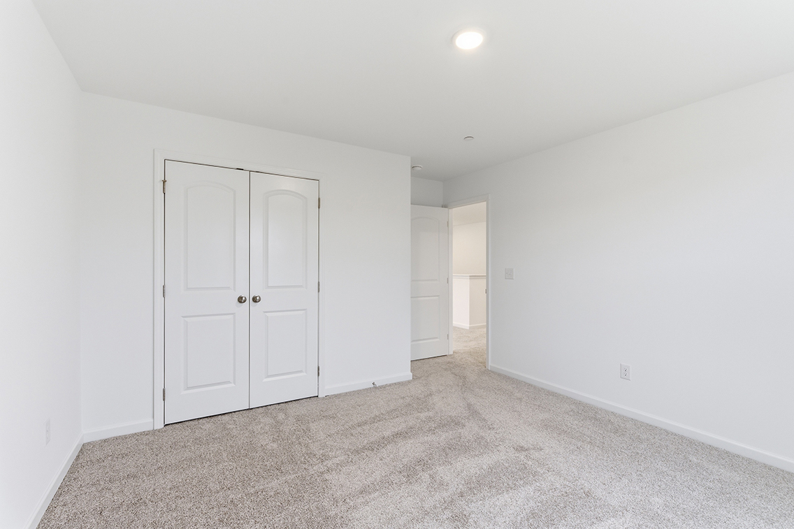 A hallway with white doors.