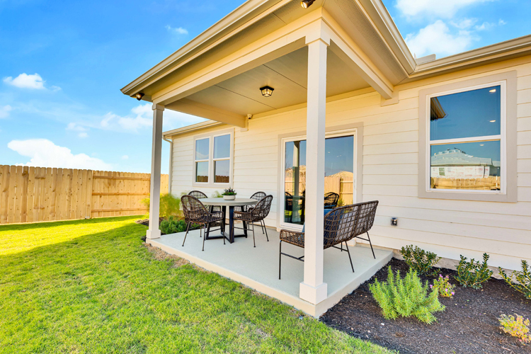 A patio with a table and chairs.