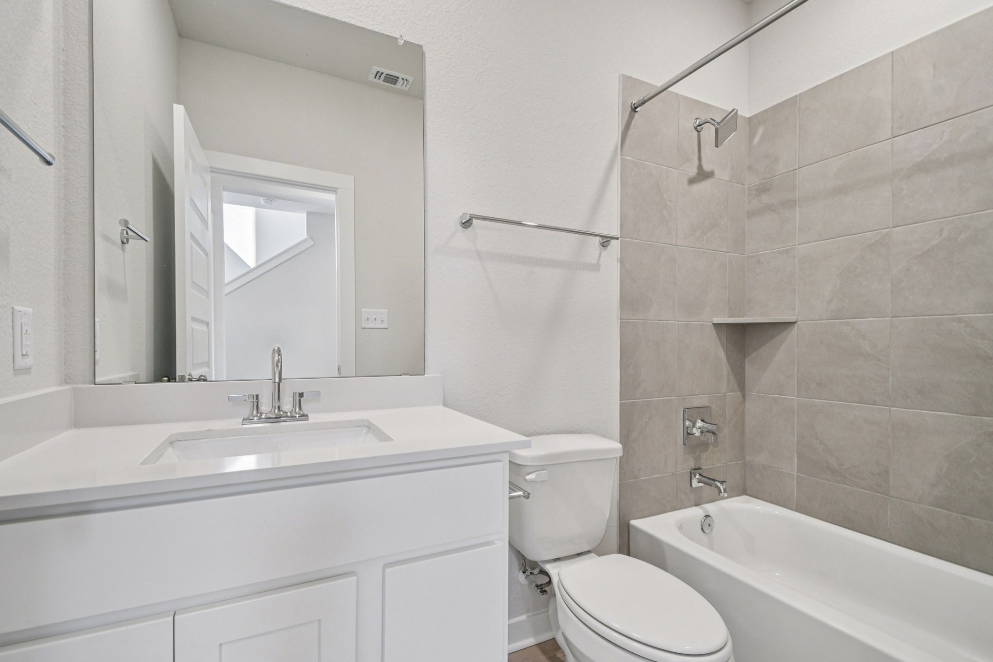 A bathroom with a sink toilet and bathtub.