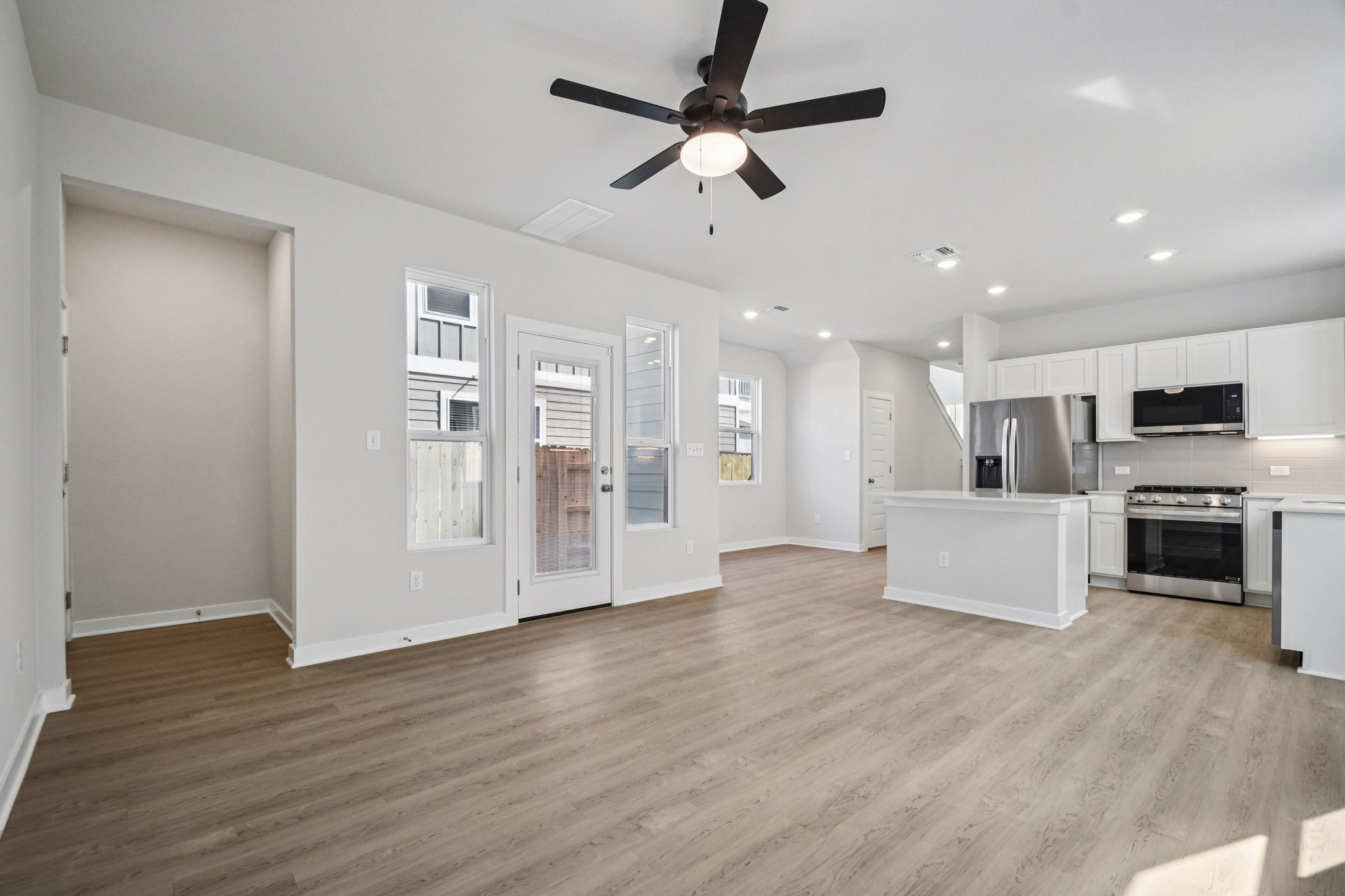 A kitchen with white cabinets.