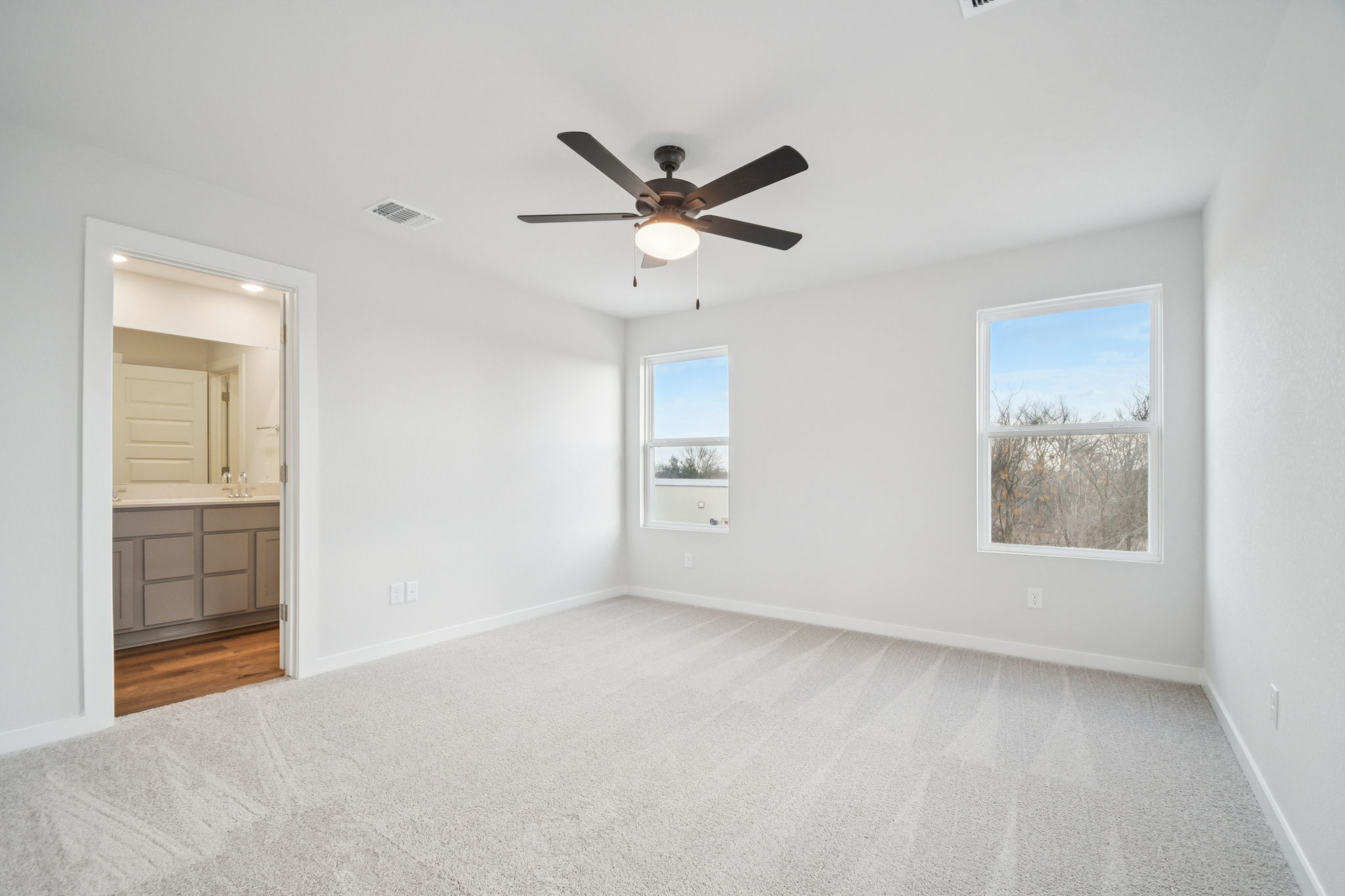 A room with a ceiling fan and a window.