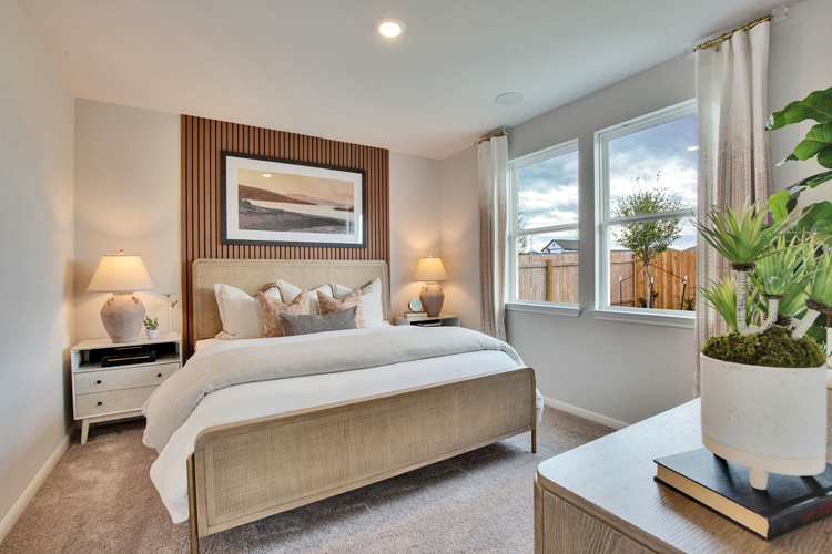 A bedroom with a large window.