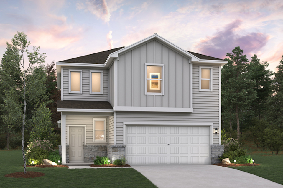 A house with a garage and trees around it.