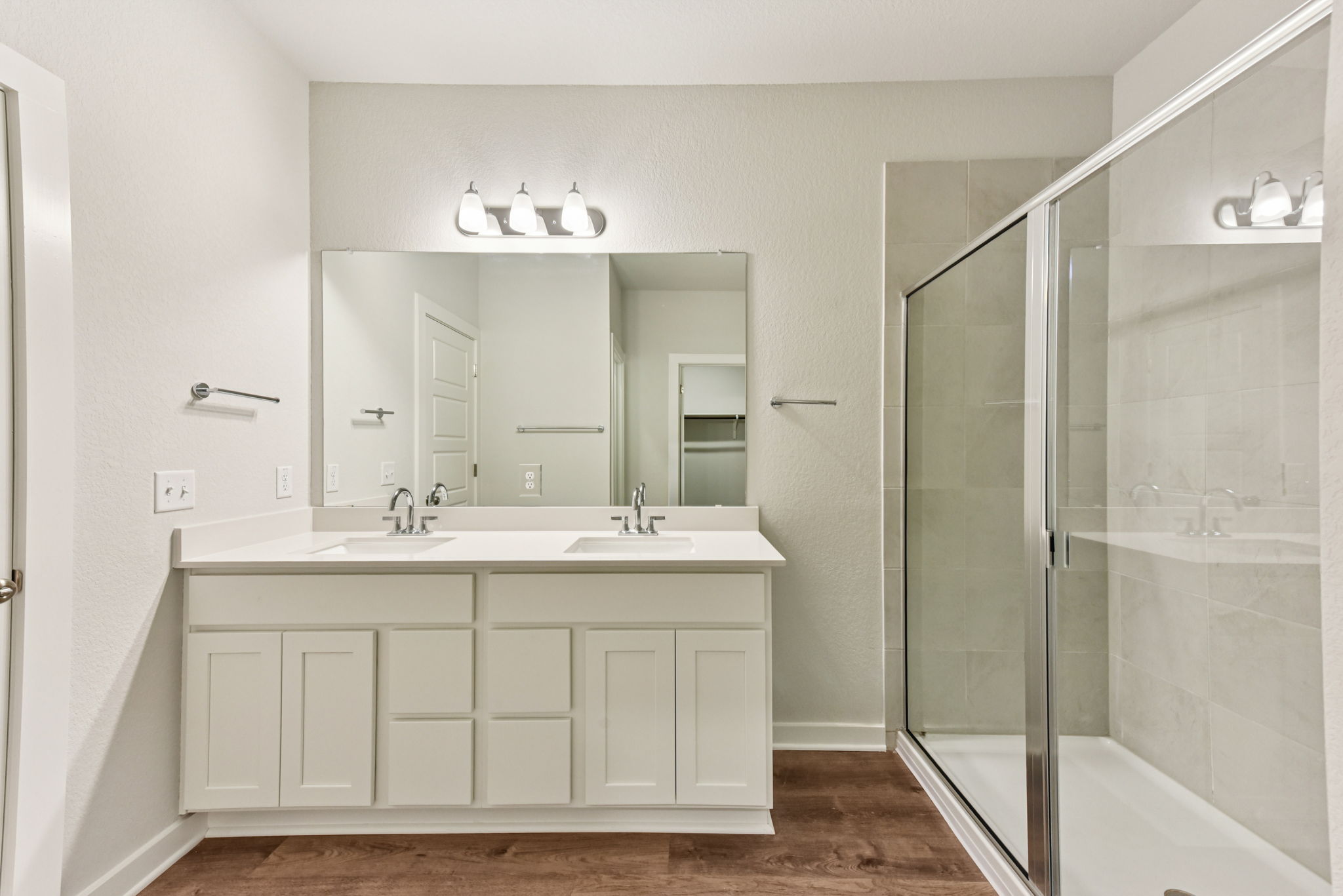 A bathroom with a glass shower.