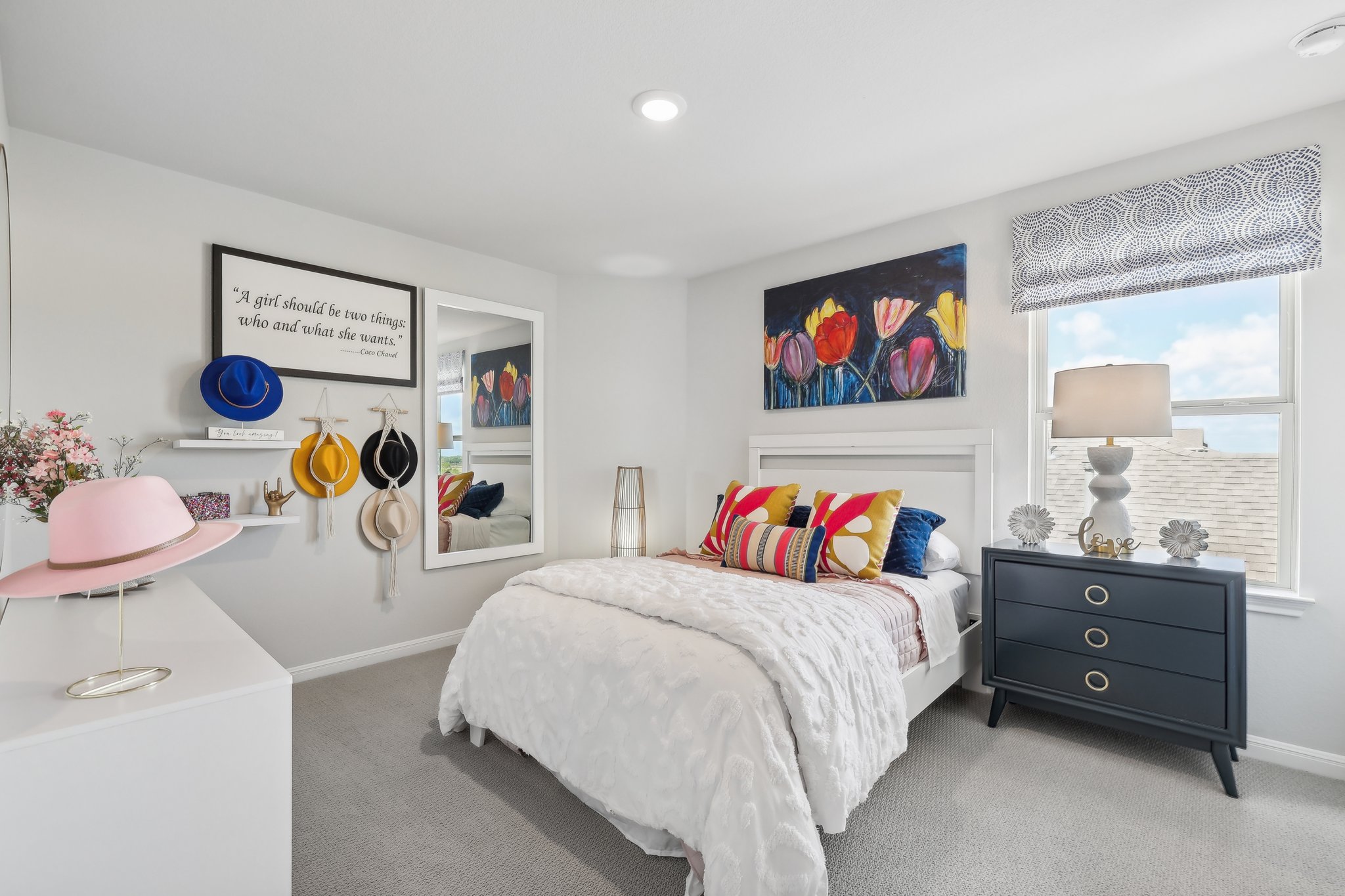 A bedroom with a bed and a dresser.