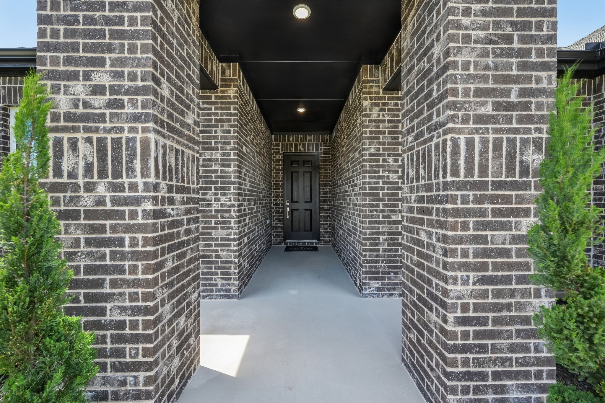A walkway between brick buildings.