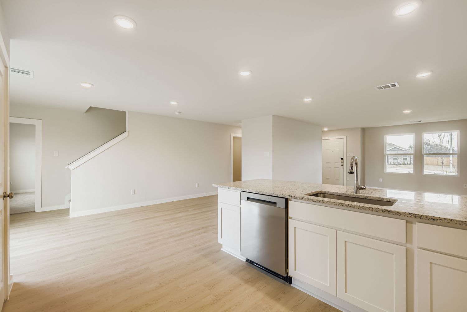 A large kitchen with white cabinets.