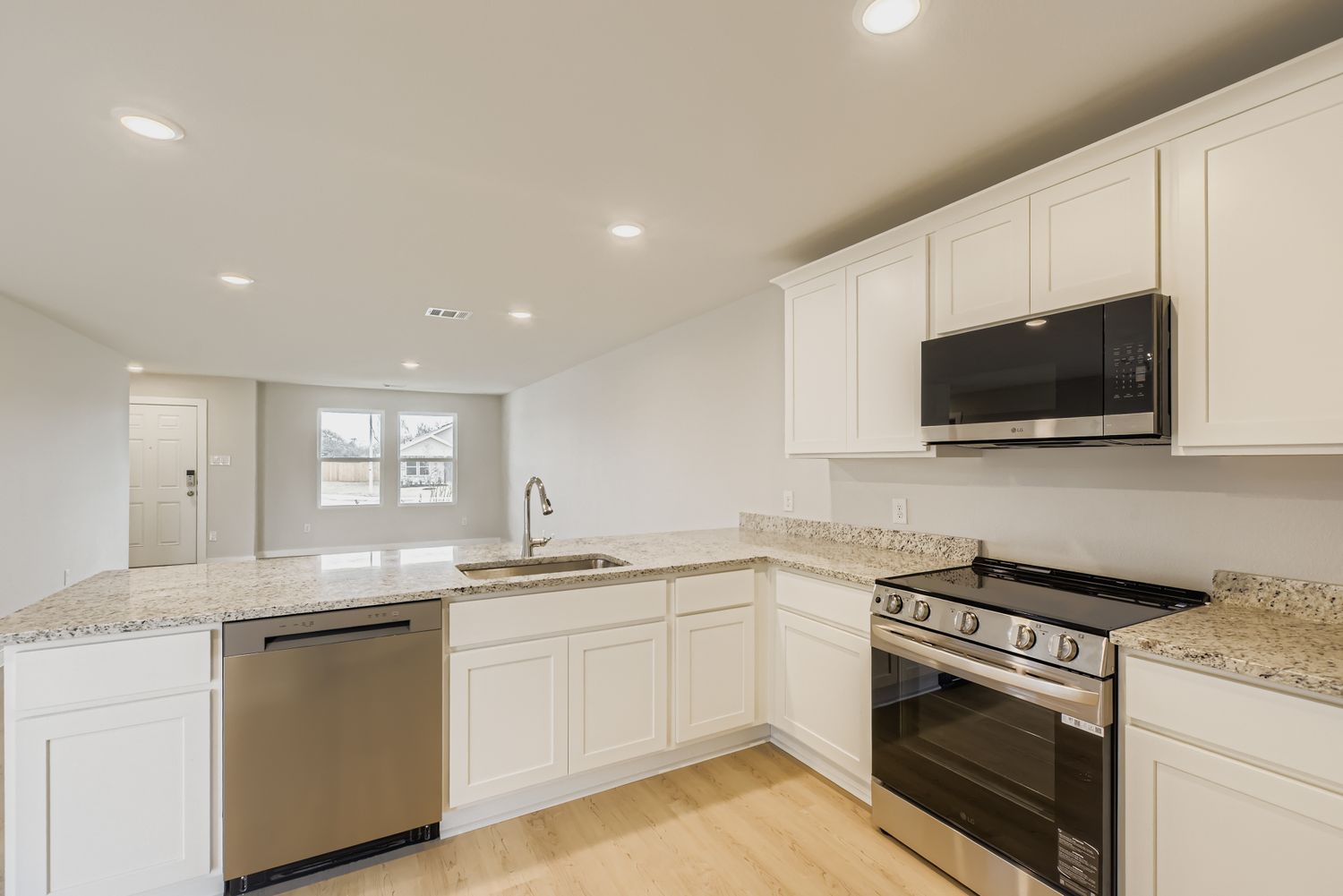 A kitchen with white cabinets.