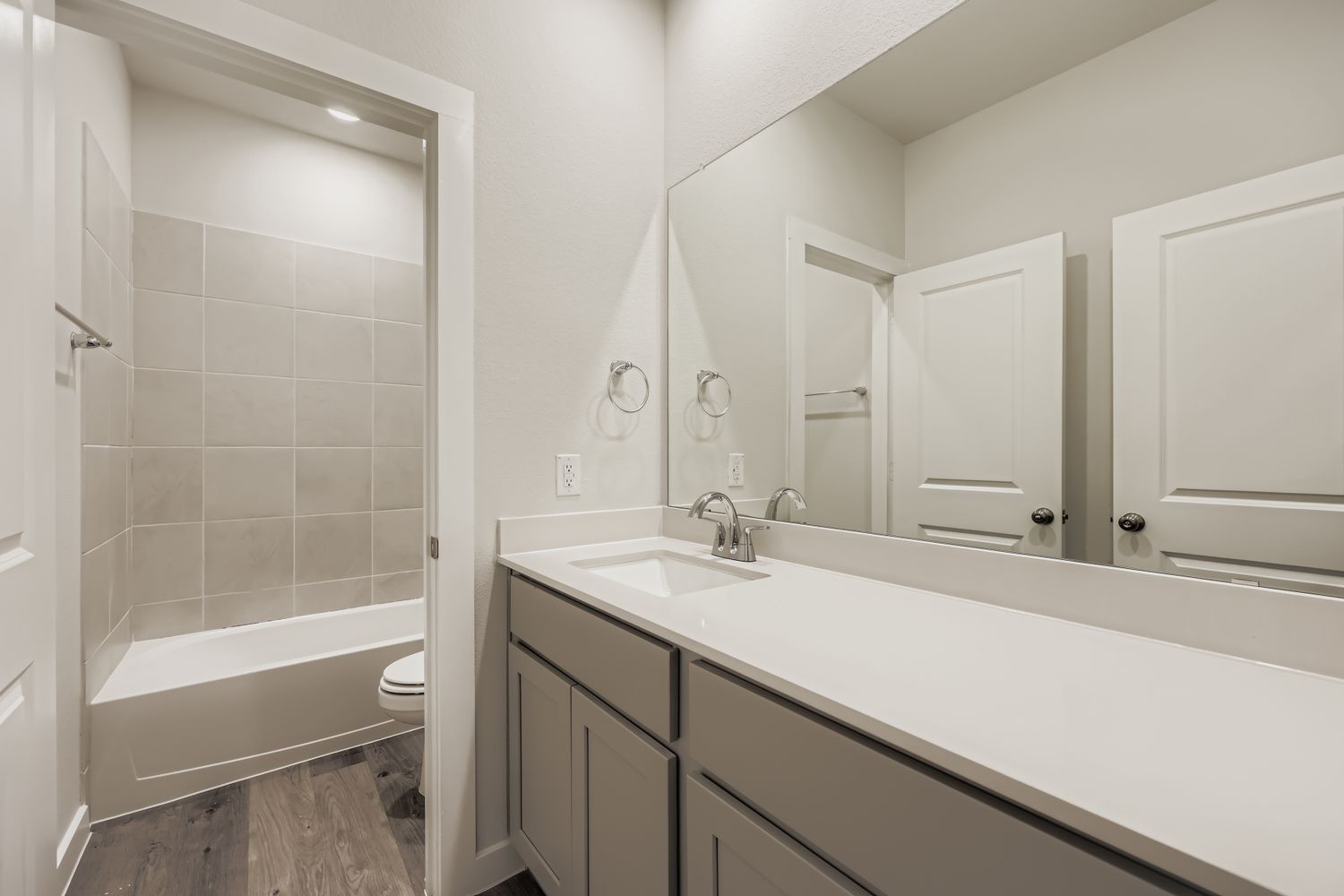 A bathroom with a tub sink and toilet.