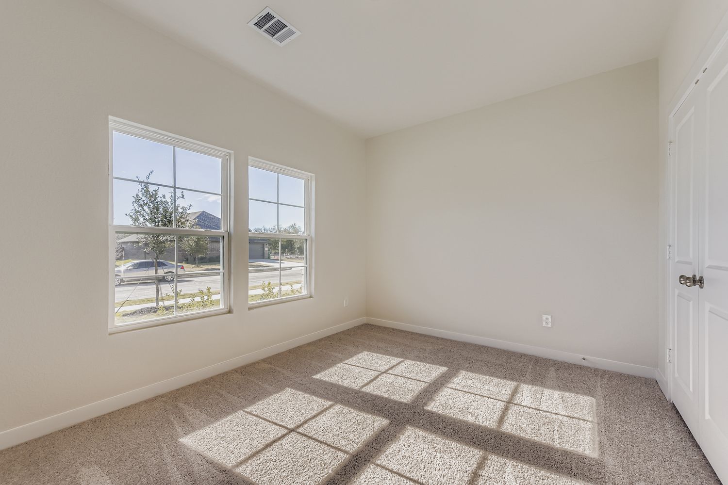 A room with a tile floor and windows.