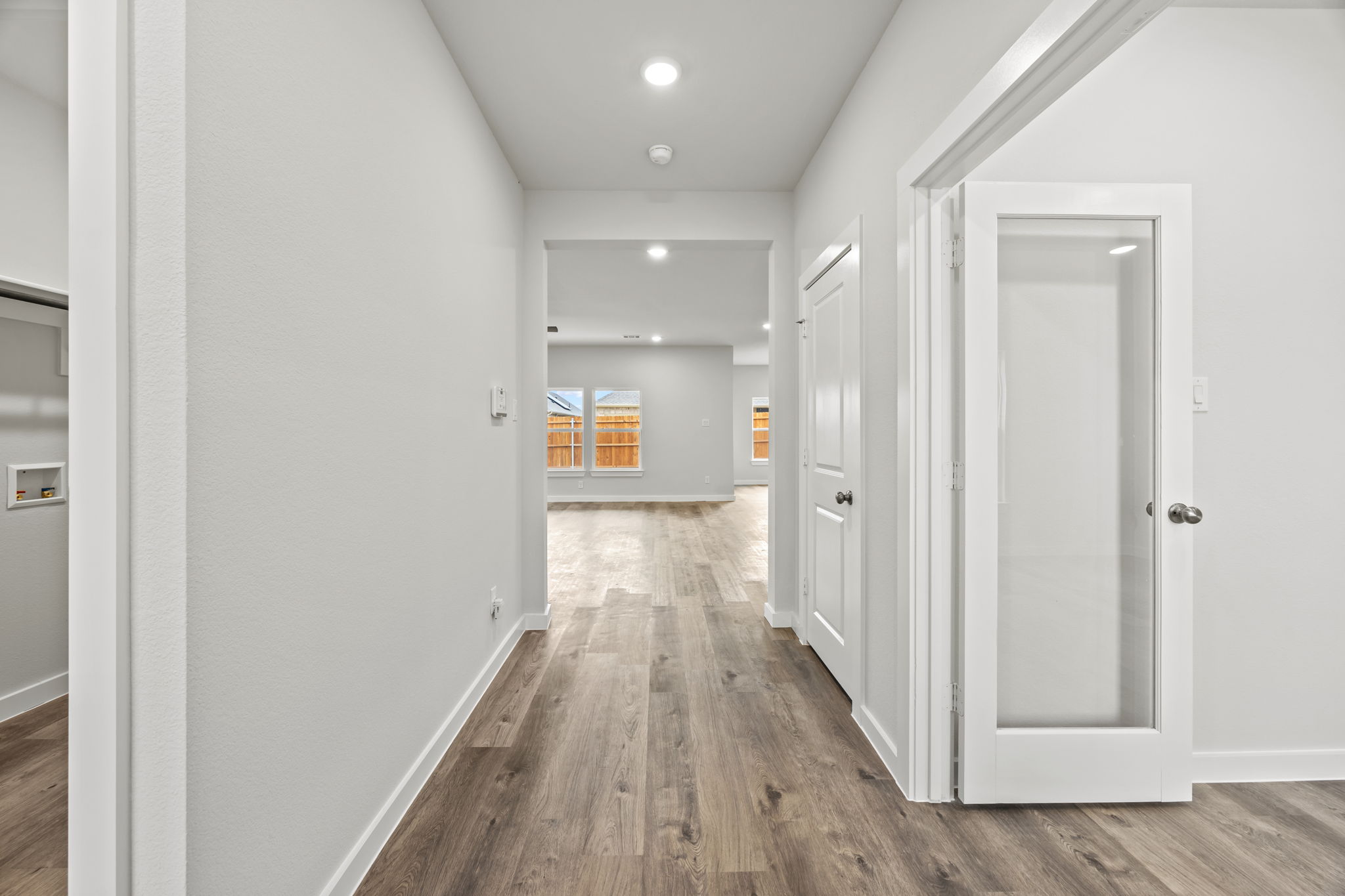 A hallway with white doors.