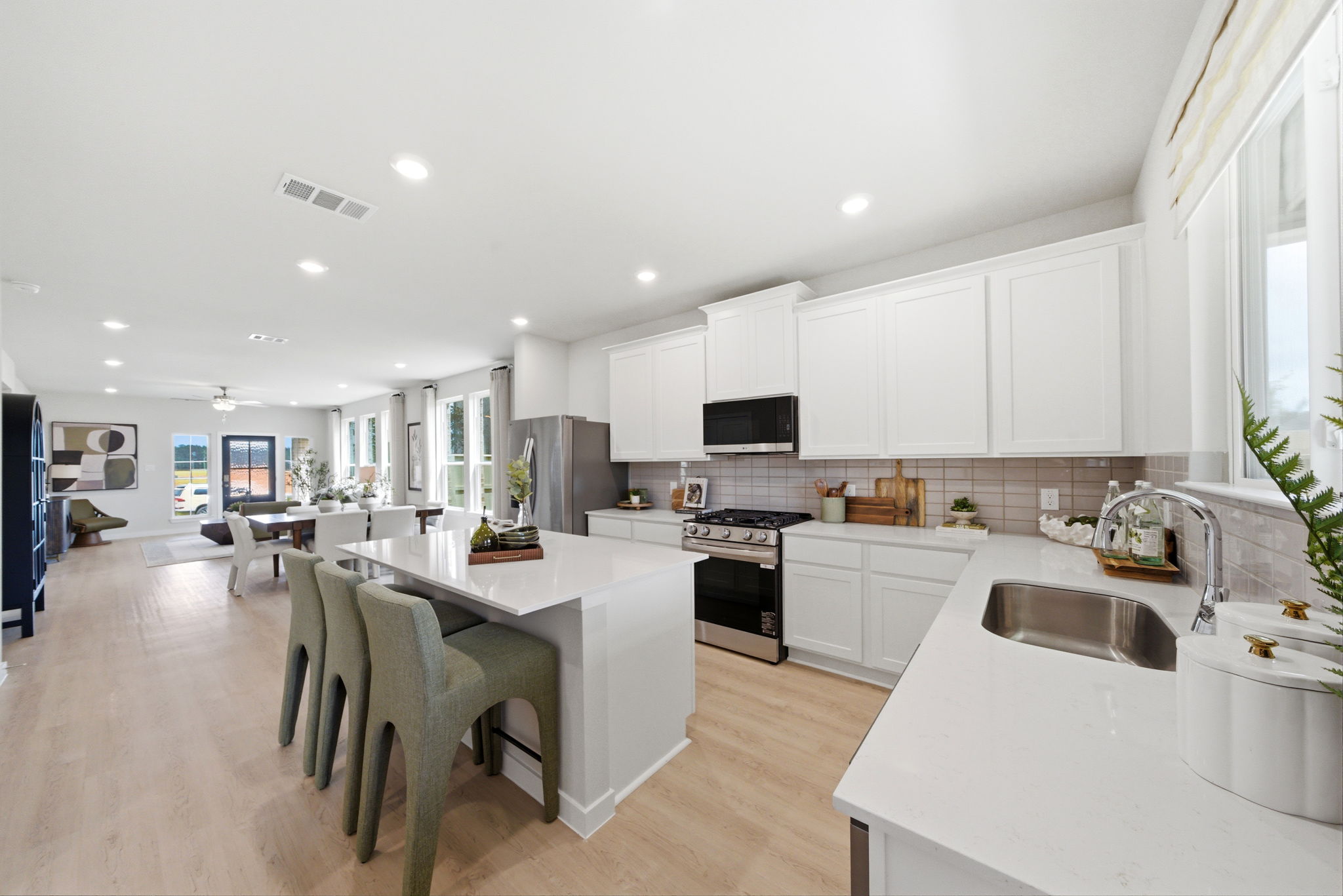 A kitchen with white cabinets.