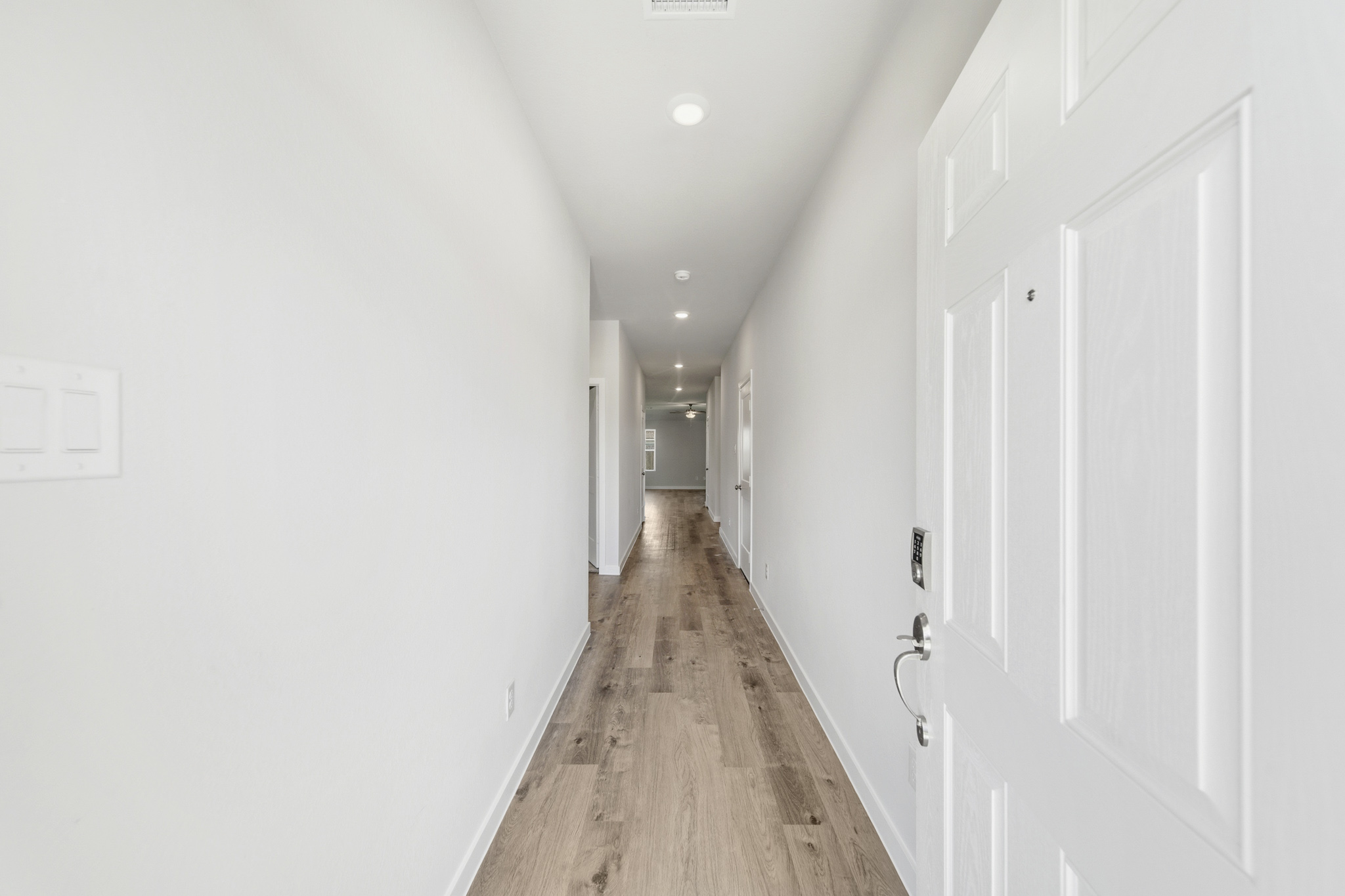 A hallway with white doors.