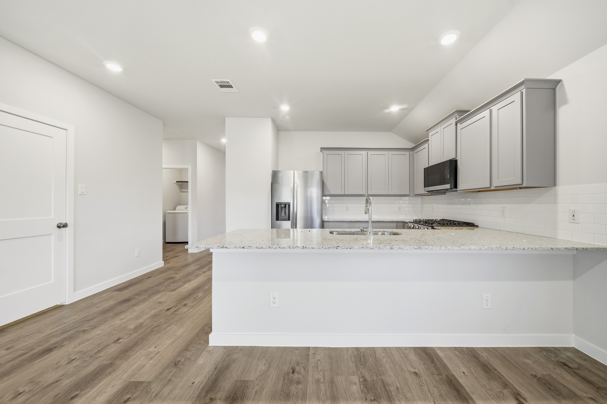 A kitchen with white cabinets.