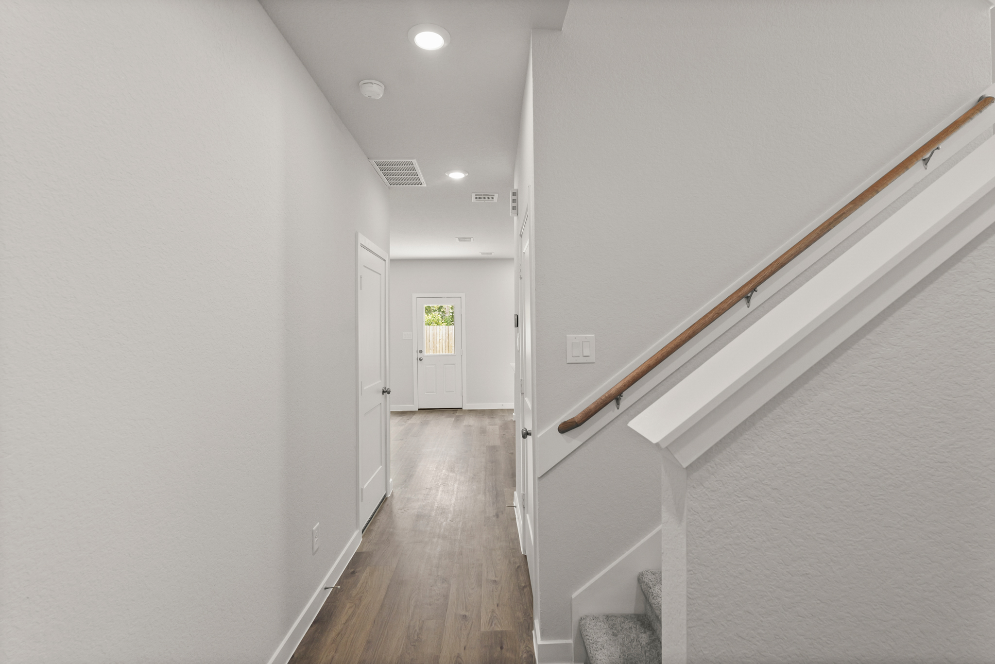 A hallway with white walls.