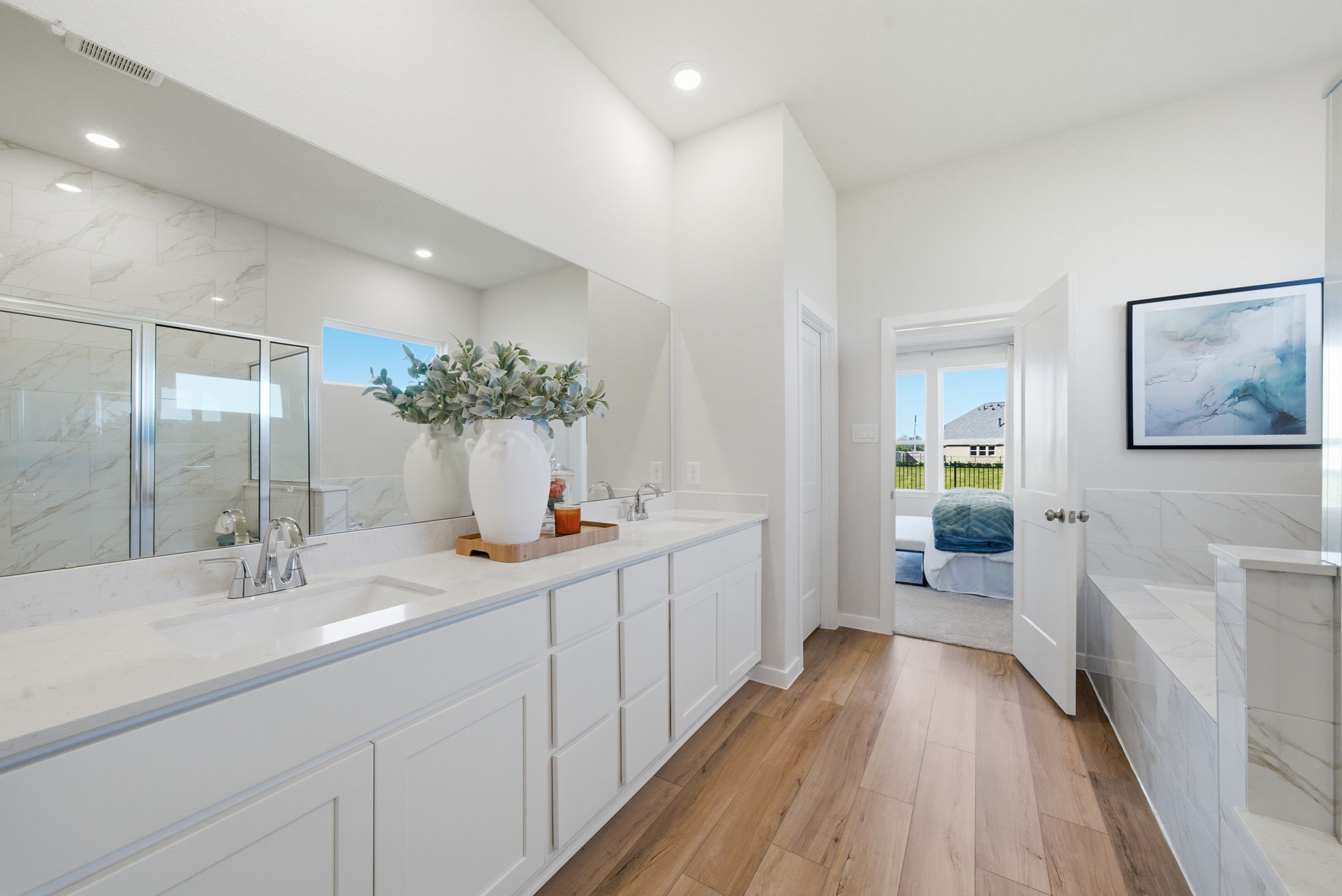 A bathroom with white cabinets.