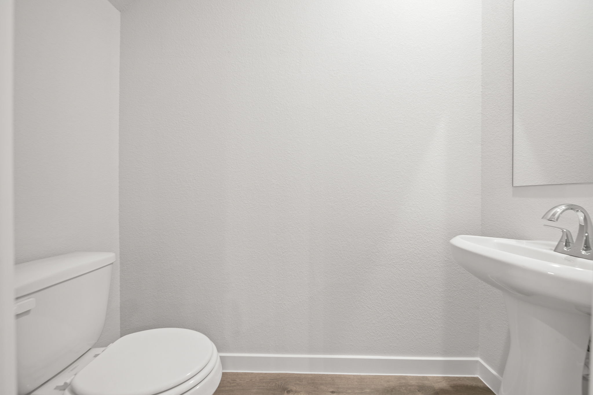 A bathroom with a toilet and sink.