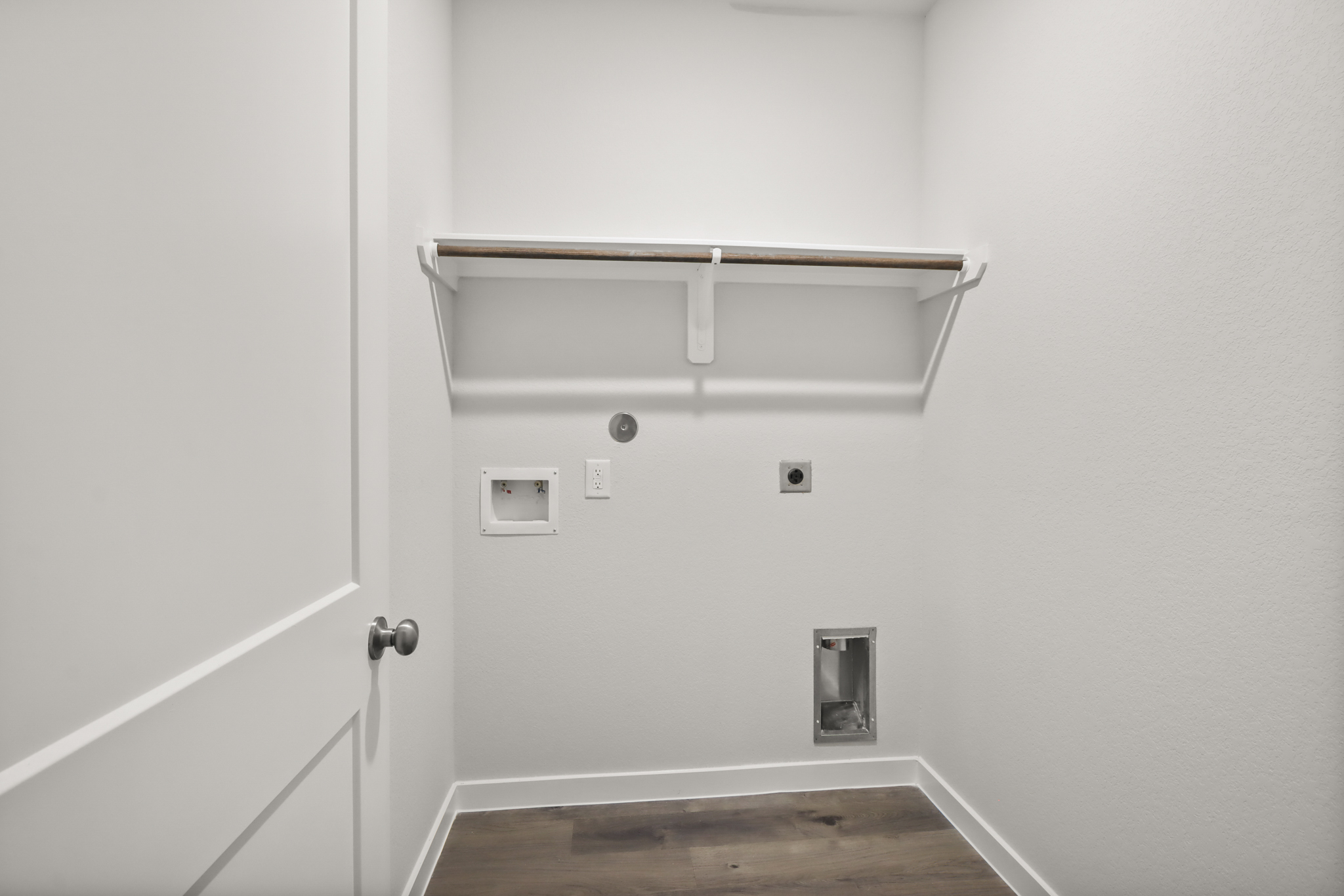 A white door with a metal bar.