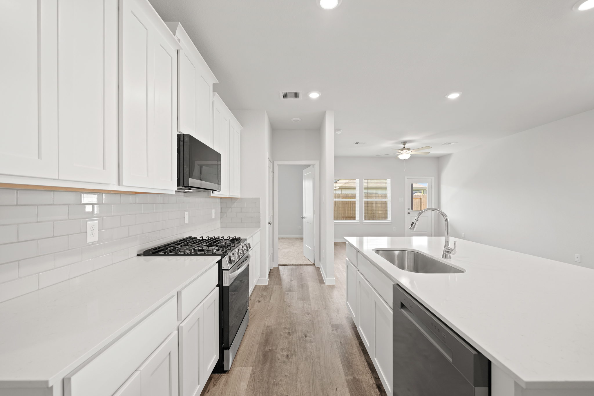 A kitchen with white cabinets.