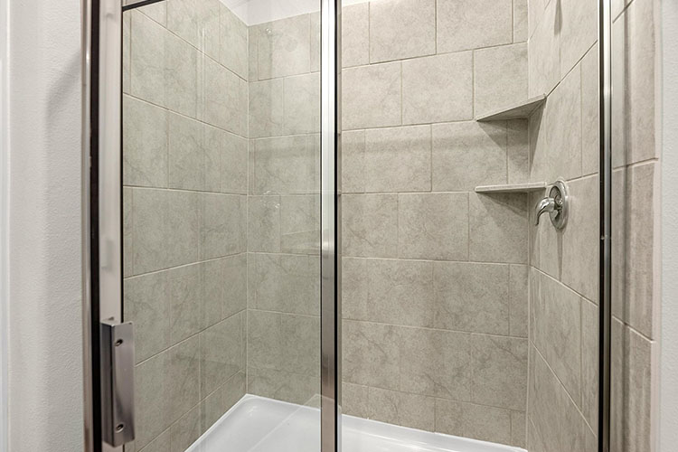 A shower with a glass door.